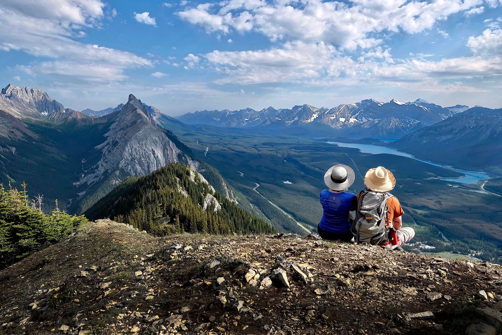 People sitting on top of a mountain. 