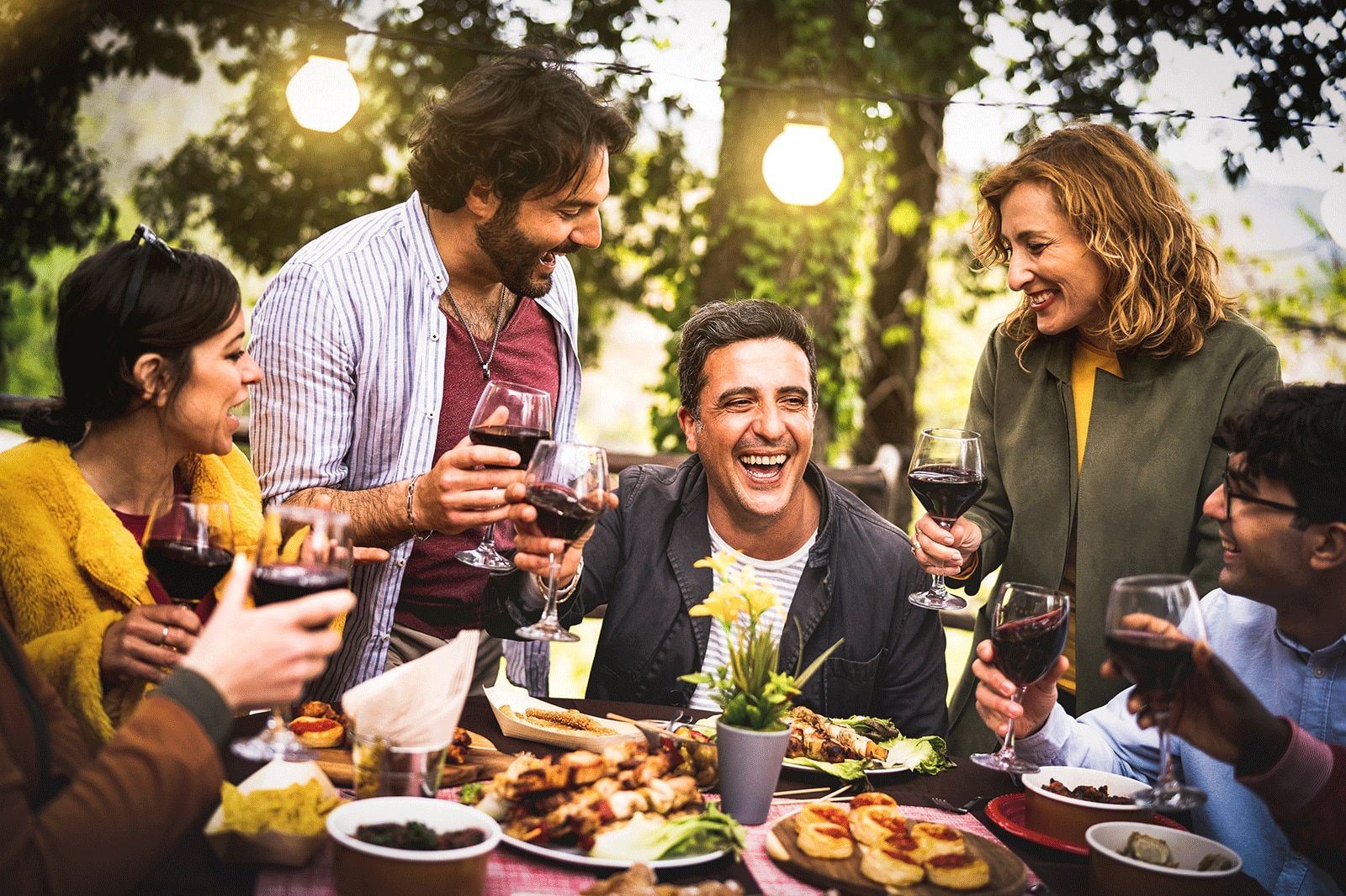 Young men and women having fun drinking out at a restaurant. 