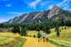 People hiking in front of mountains.