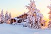 A lodge in between snow covered trees.