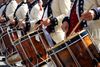 A row of drummers in American colonial costumes.