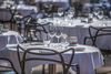 Restaurant tables on a terrace.