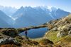 A hiker looking at a snow-covered mountain range.