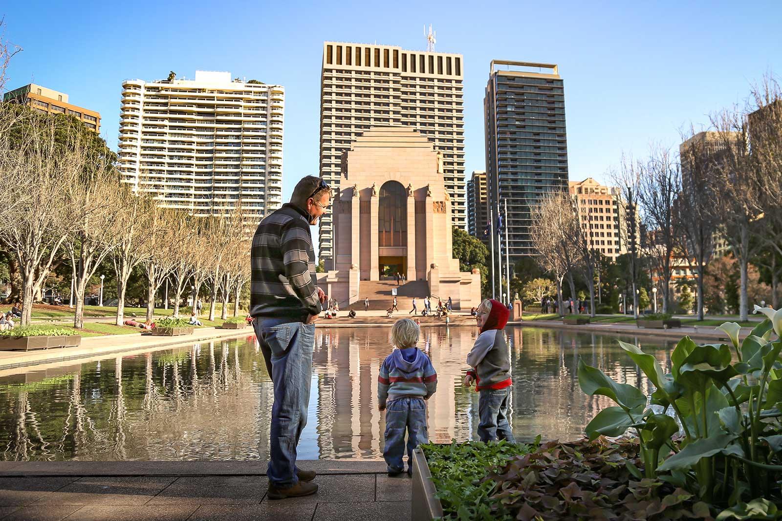 Two children and a parent in a park.