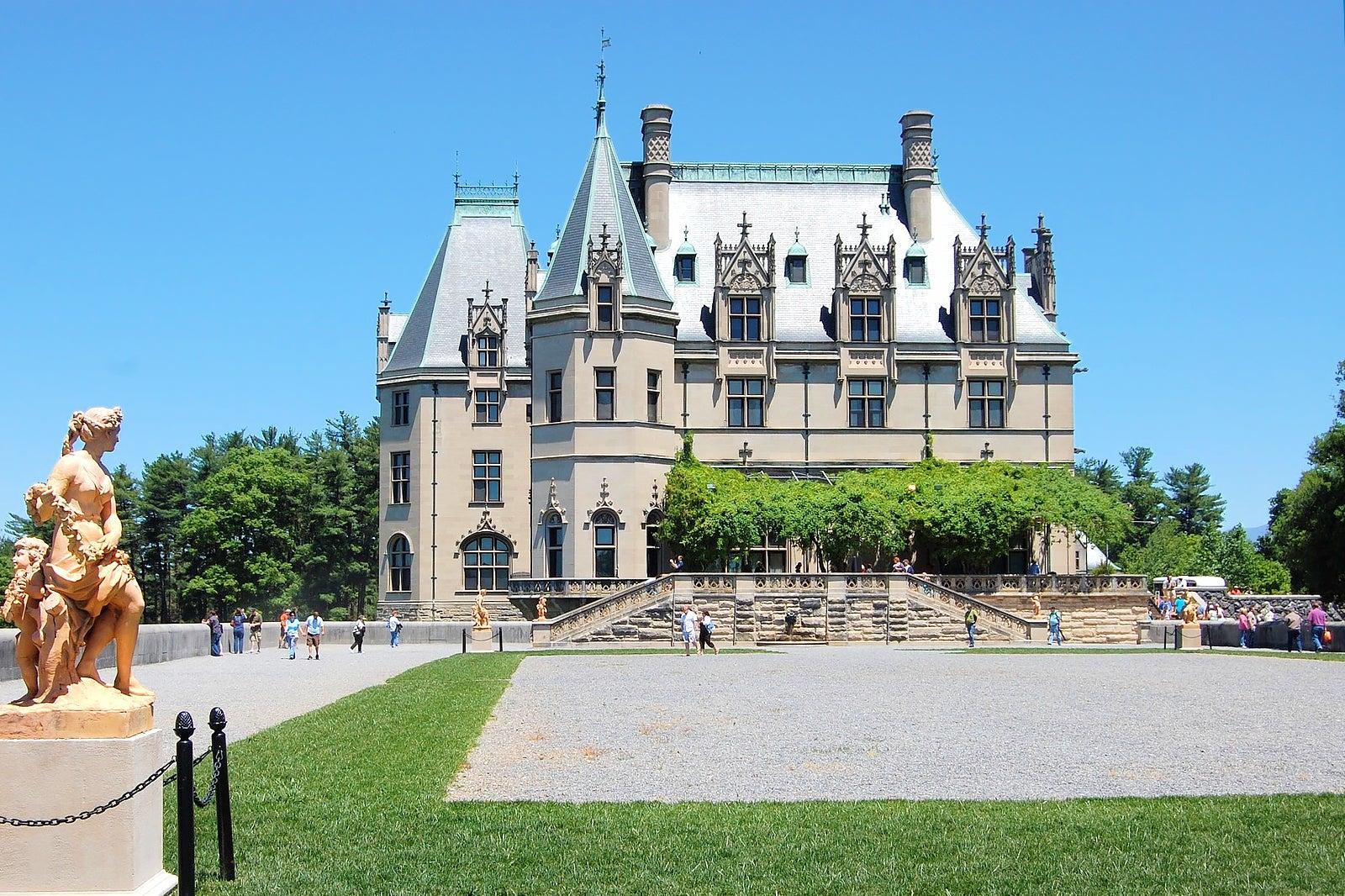 A statue and a grand old building.
