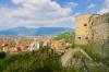 View of Brescia city from the medieval castle walls with mountains in the background.