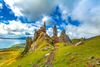 Rock pillars on a grassy mountain.