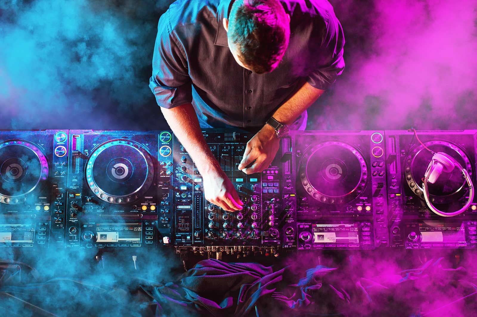 A DJ working the decks at a nightclub.