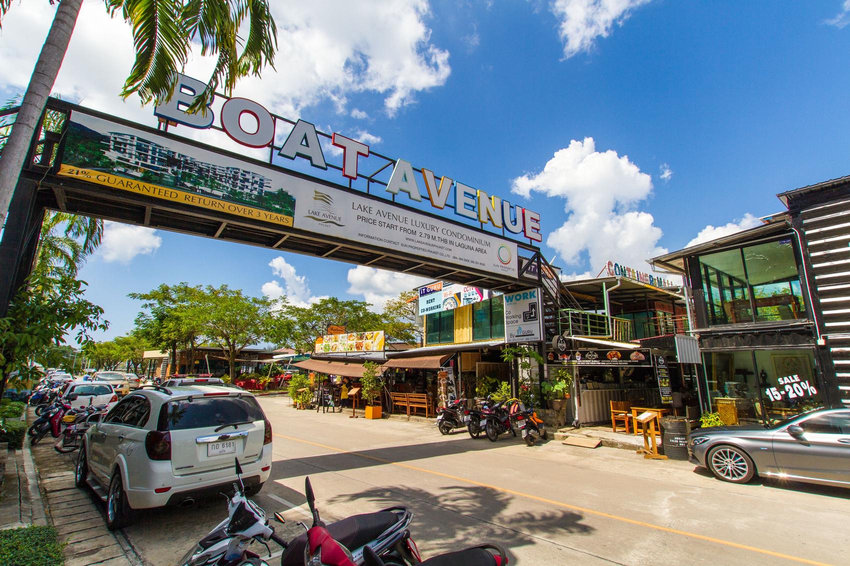 Street lined with parked cars on Boat Avenue in Phuket.