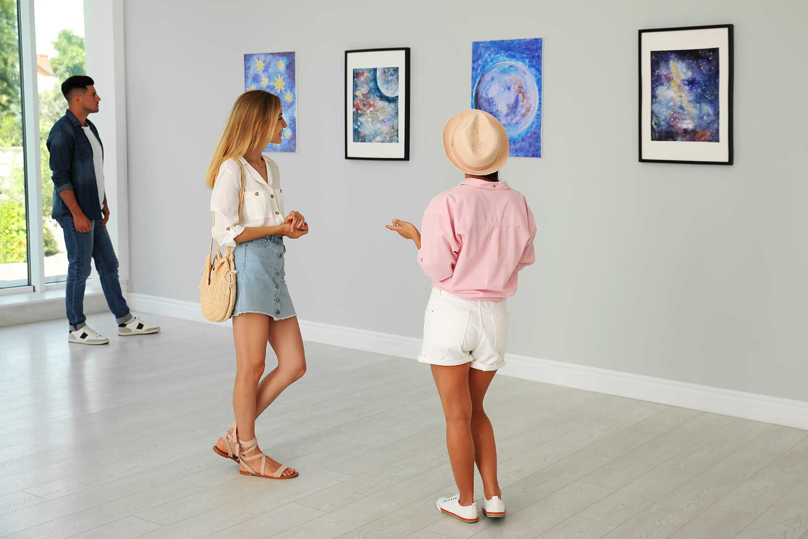 Woman standing looking at art.
