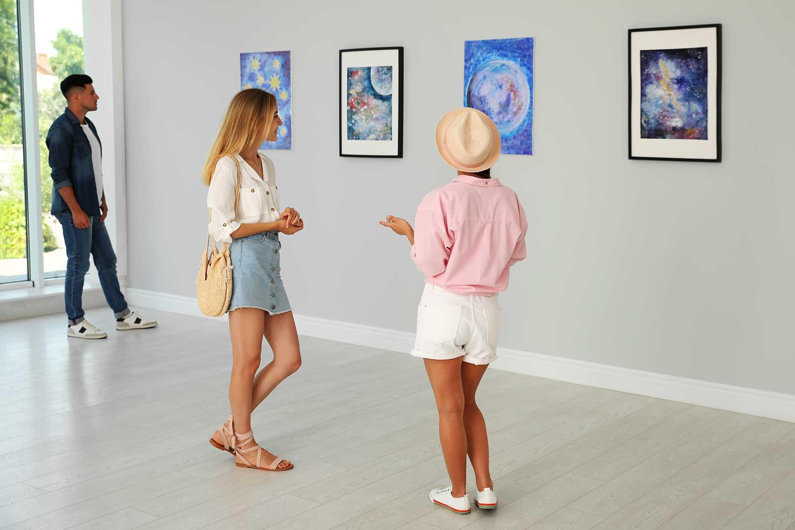 Woman standing looking at art.
