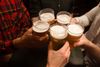 A group of men toasting with beer glasses.