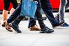 Feet of pedestrians walking on the crosswalk