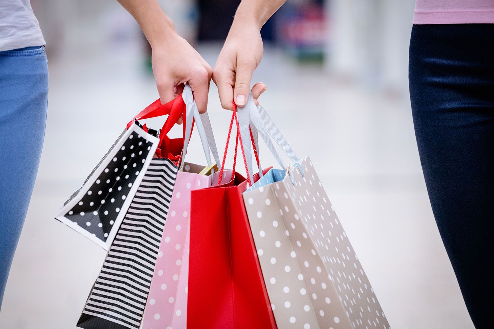 Two women carrying shopping bags.
