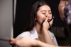 A woman having her make up done.