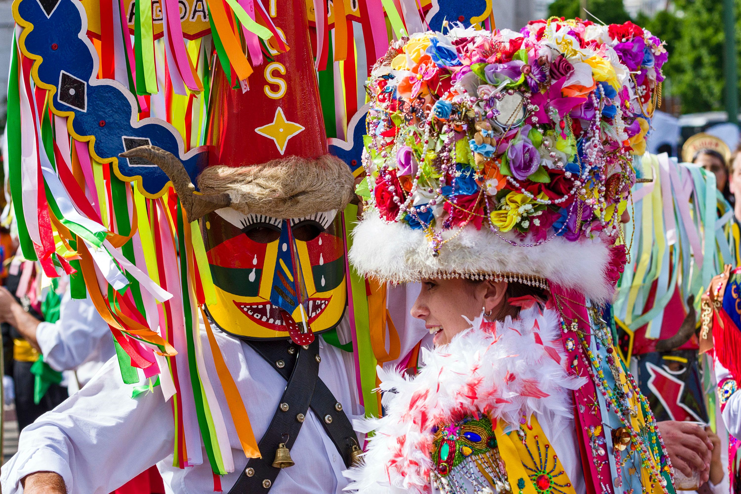 Two people dressed in costume for a festival.