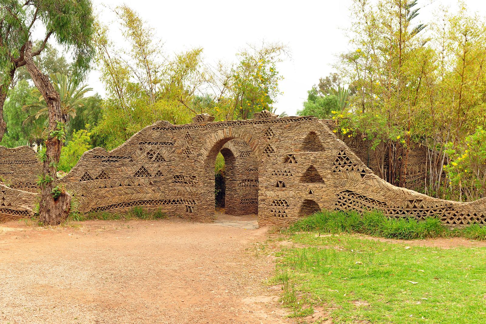 A large stone wall entrance to a park.