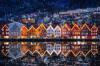 A city skyline view of the houses lit up during Christmas time in Bergen, Norway.