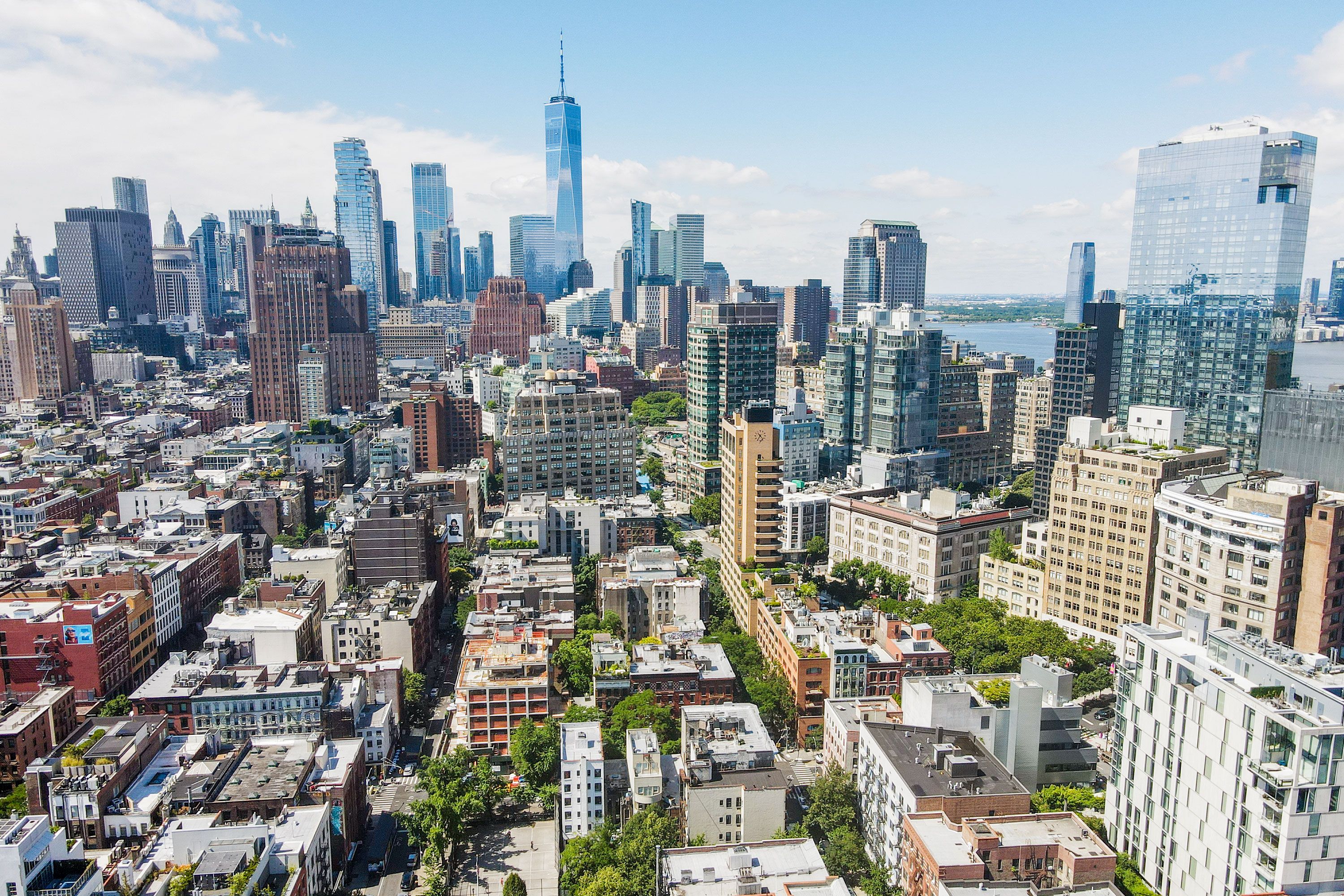 Aerial view of buildings in SoHo with large skyscrapers in the background in New York City.