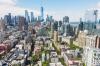 Aerial view of buildings in SoHo with large skyscrapers in the background in New York City.
