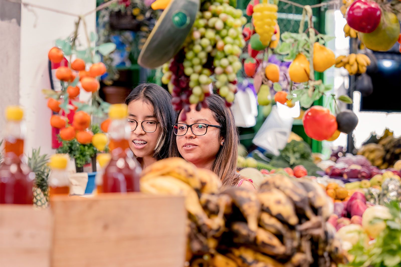 The women buyers strolling at a fruit market.