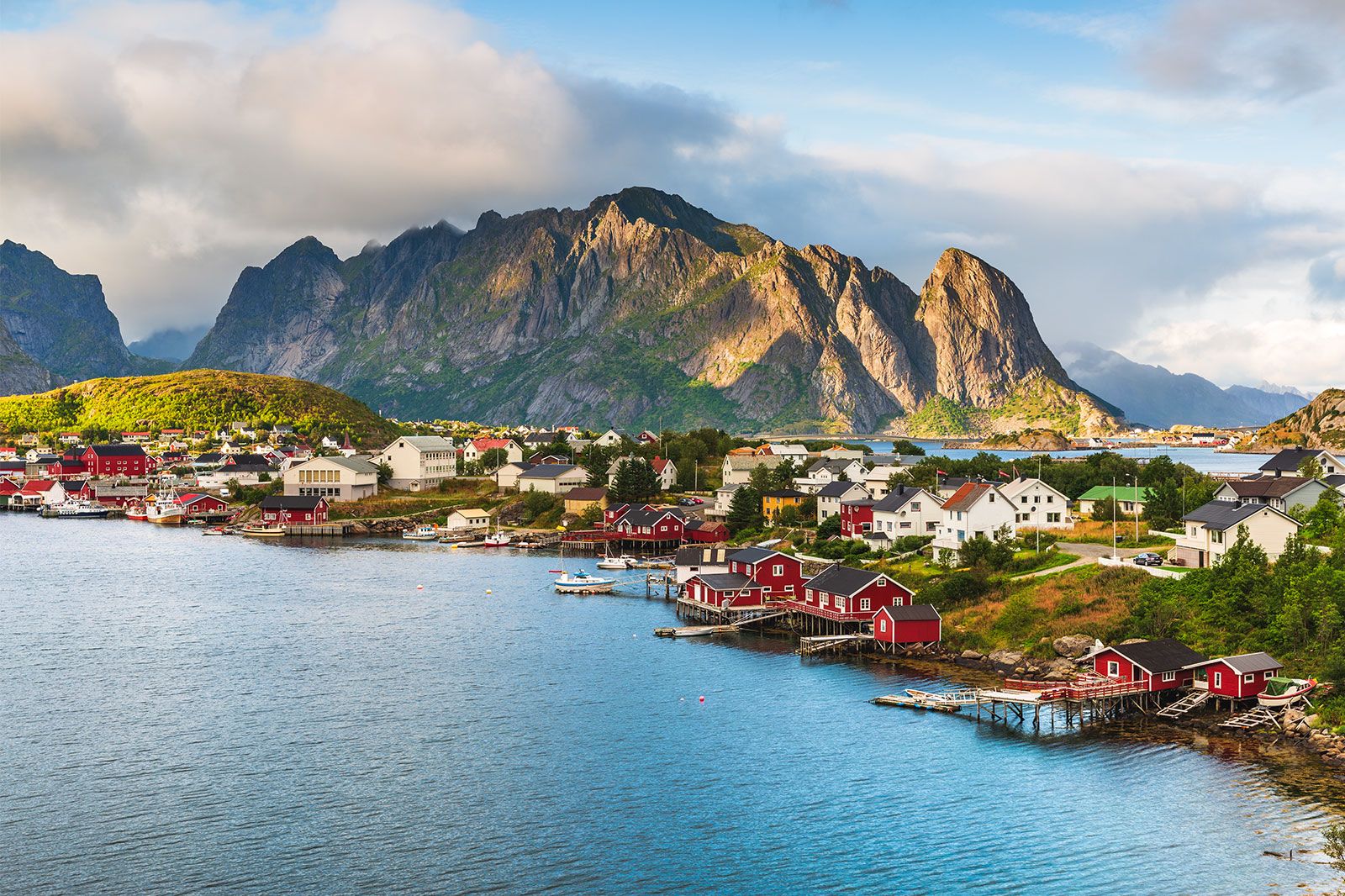A coastal town with a large mountain in the background.