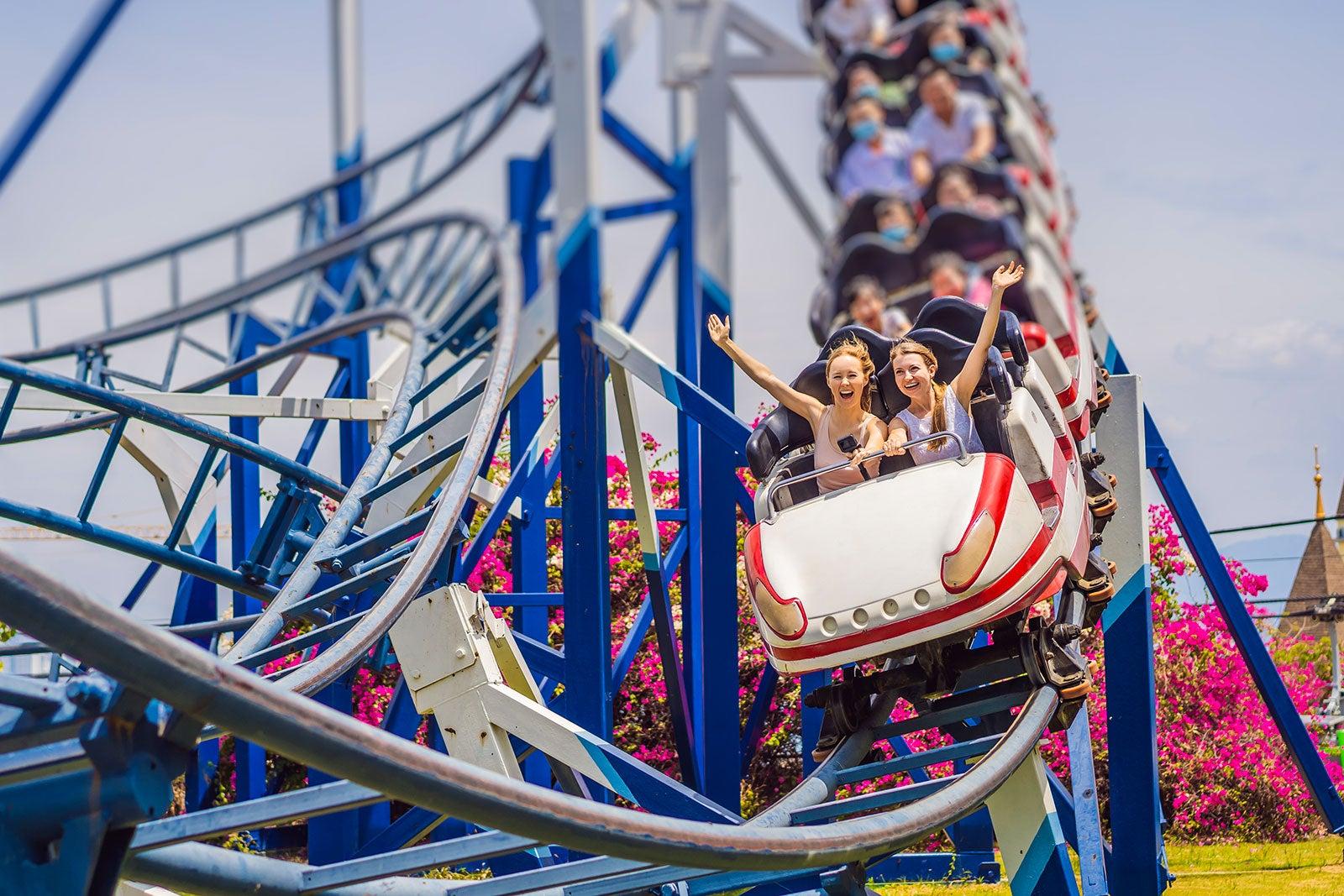 People having fun on a rollercoaster.