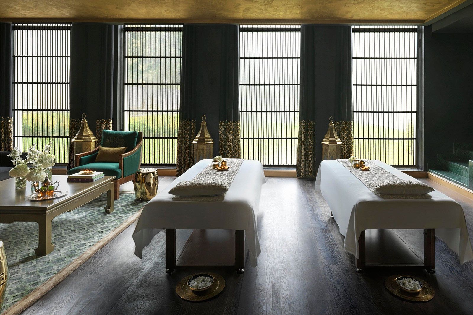 Two spa bed lay in a dimly lit spa room. 