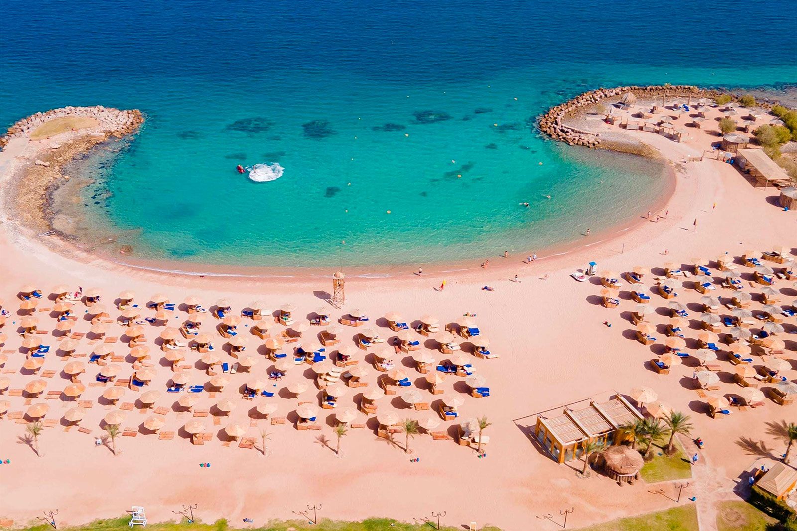 Umbrellas and beach chairs on a beach.