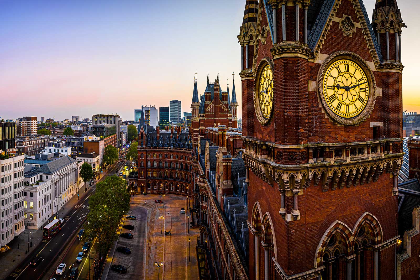 Clock tower and a view of a street lined by buildings.