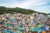 A town full of colorful houses situated on a hill.