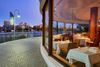 View of a restaurant interior, deck and the water in Brisbane.