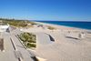 A view of a cement path to the beach.