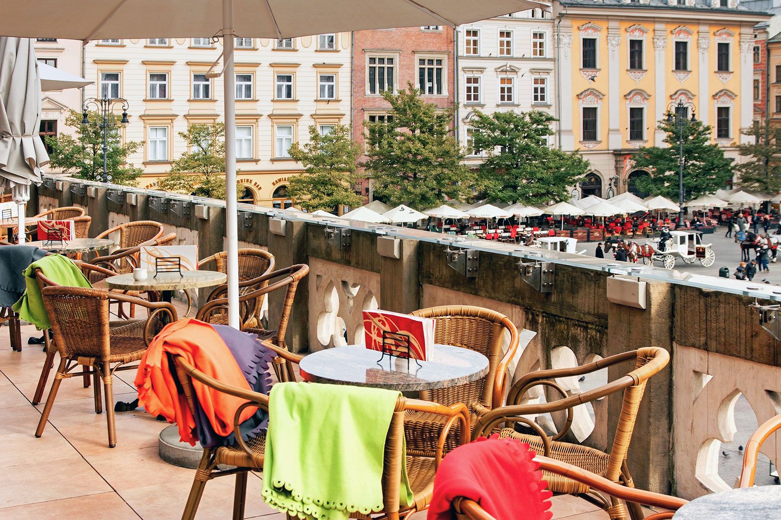An outdoor terrace cafe with tables and chairs.