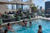 People in a rooftop pool.
