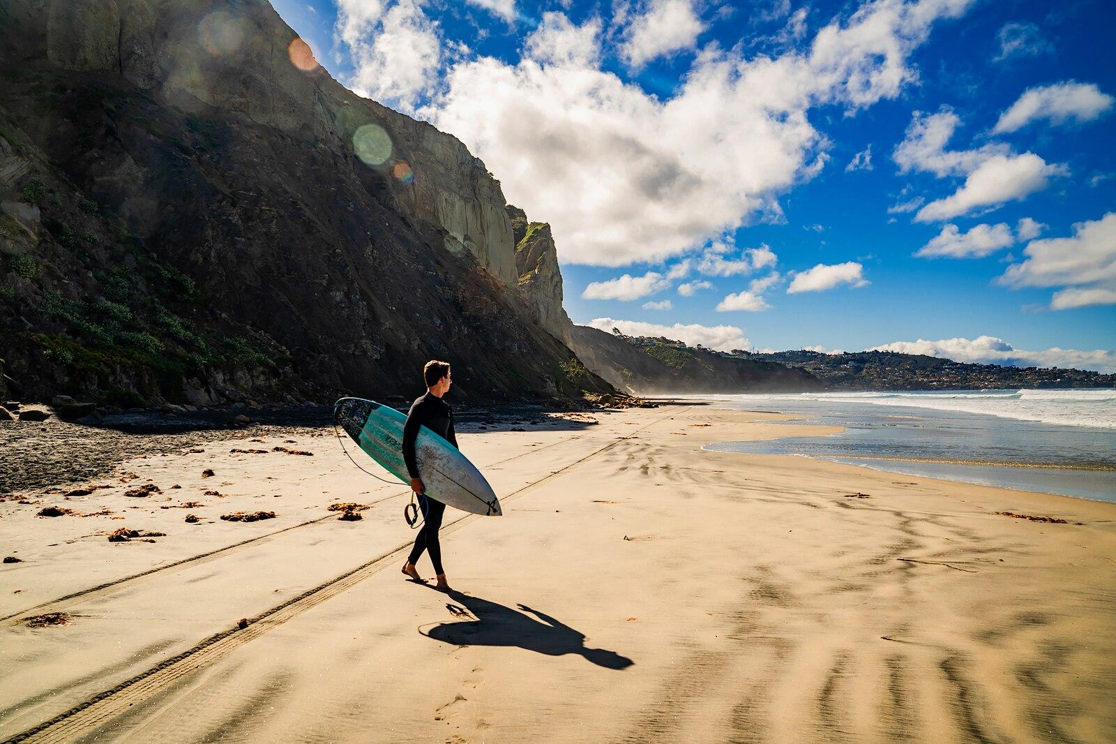 A surfer on the beach.