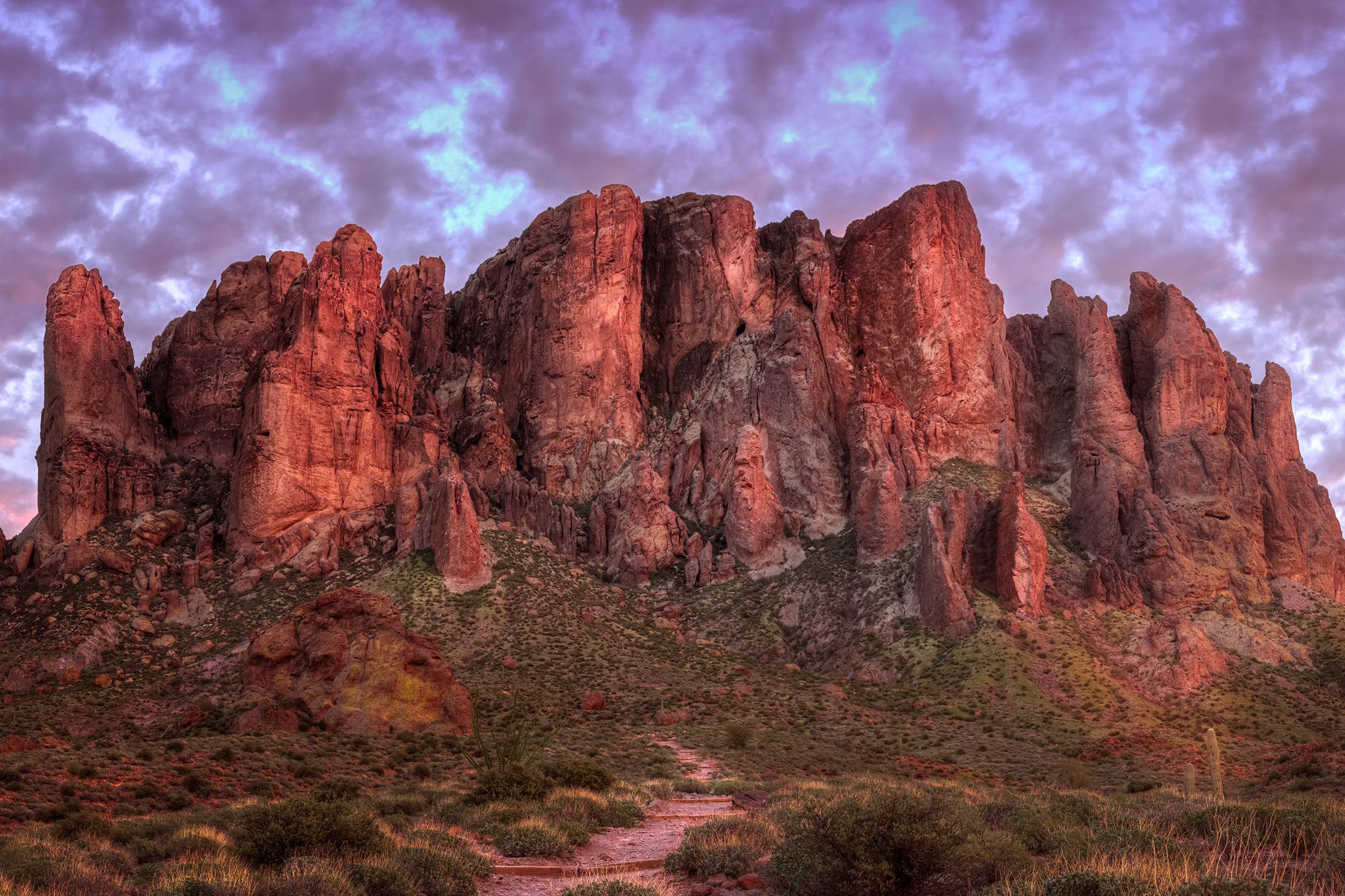 Superstition Mountains at sunset with a colorful sky.