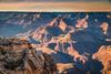 Hikers look out at a view point of the Grand Canyon.