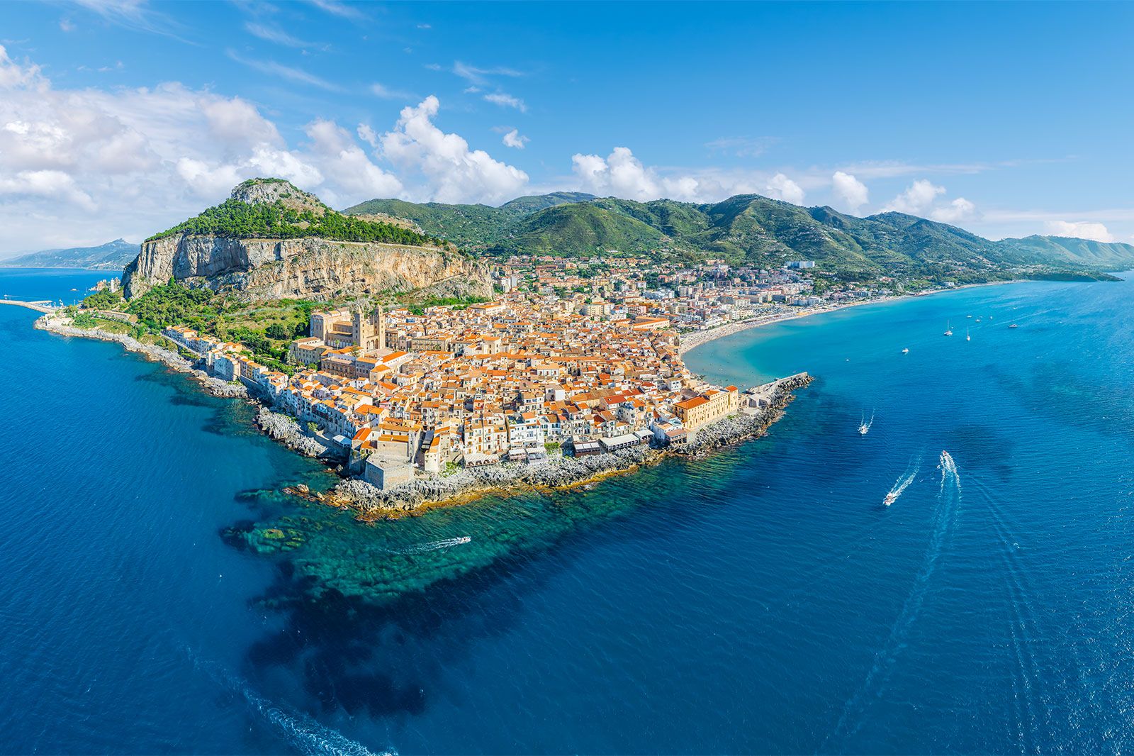 An above view of a coastal city on a rocky coast.