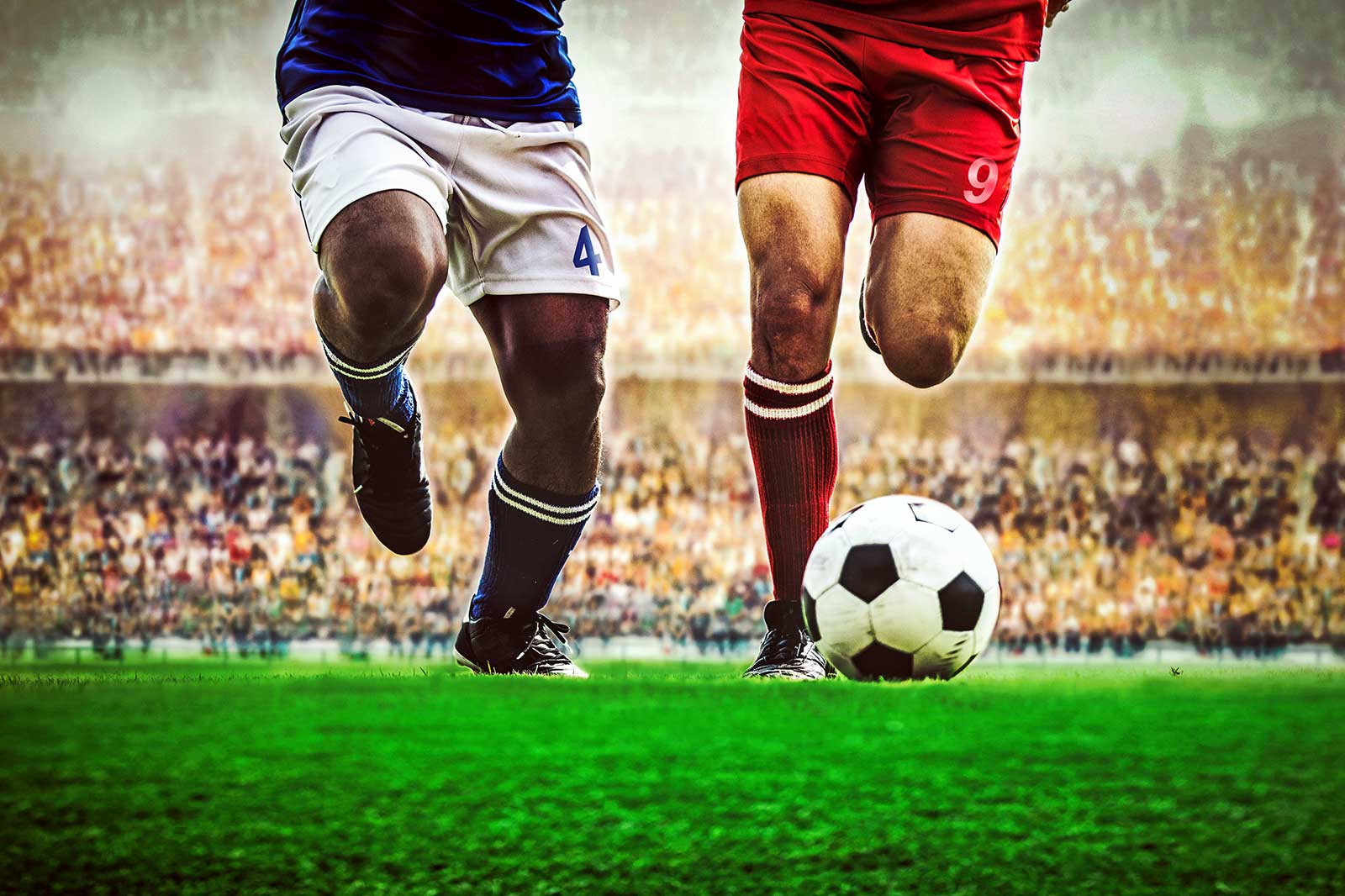 Two footballers going for the ball.