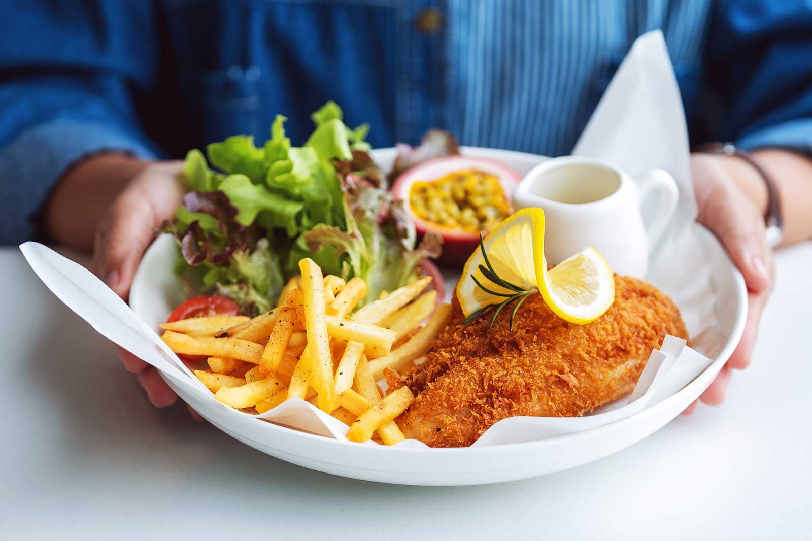 A serving of fish and chips on a plate.