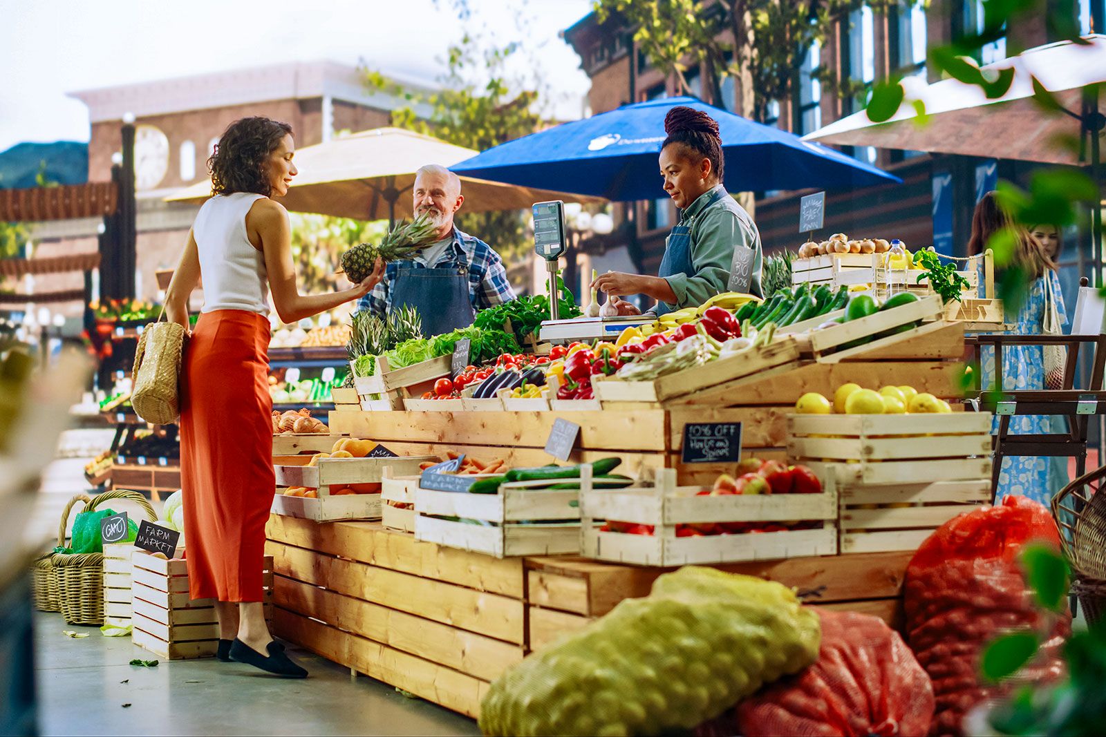 Two women at a farmers market stall.