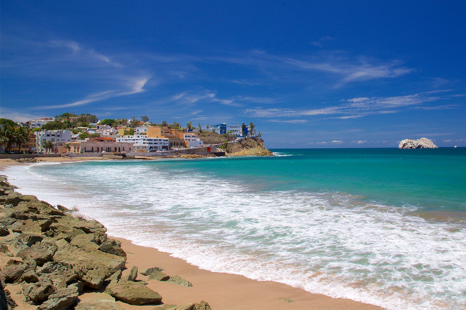 Blue water and blue sky at a coastal town and beach.