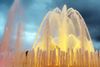Water fountain with lights coming through it.