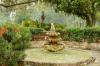 A fountain in a lush green park.