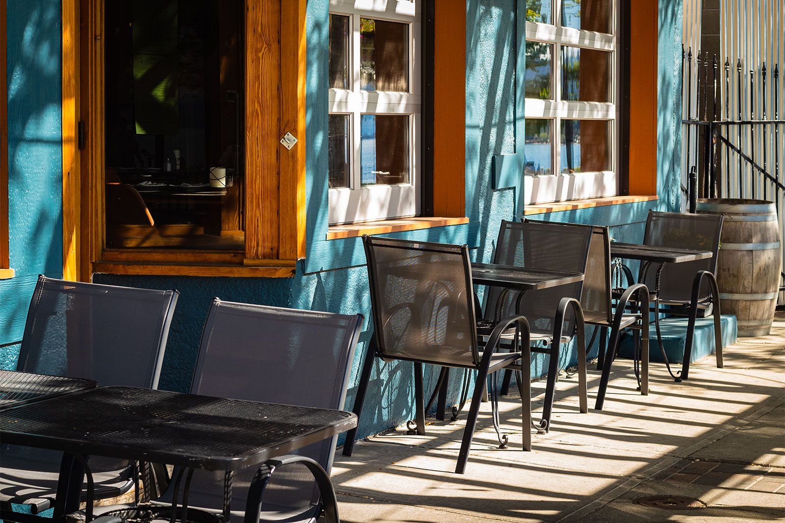 Empty restaurant summer terrace with tables and chairs.