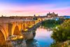 An illuminated Roman bridge of Cordoba in the evening.