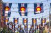 Many rows of flags are strung across a street in downtown Denver.