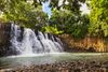 Waterfall cascading into a natural pool of water.