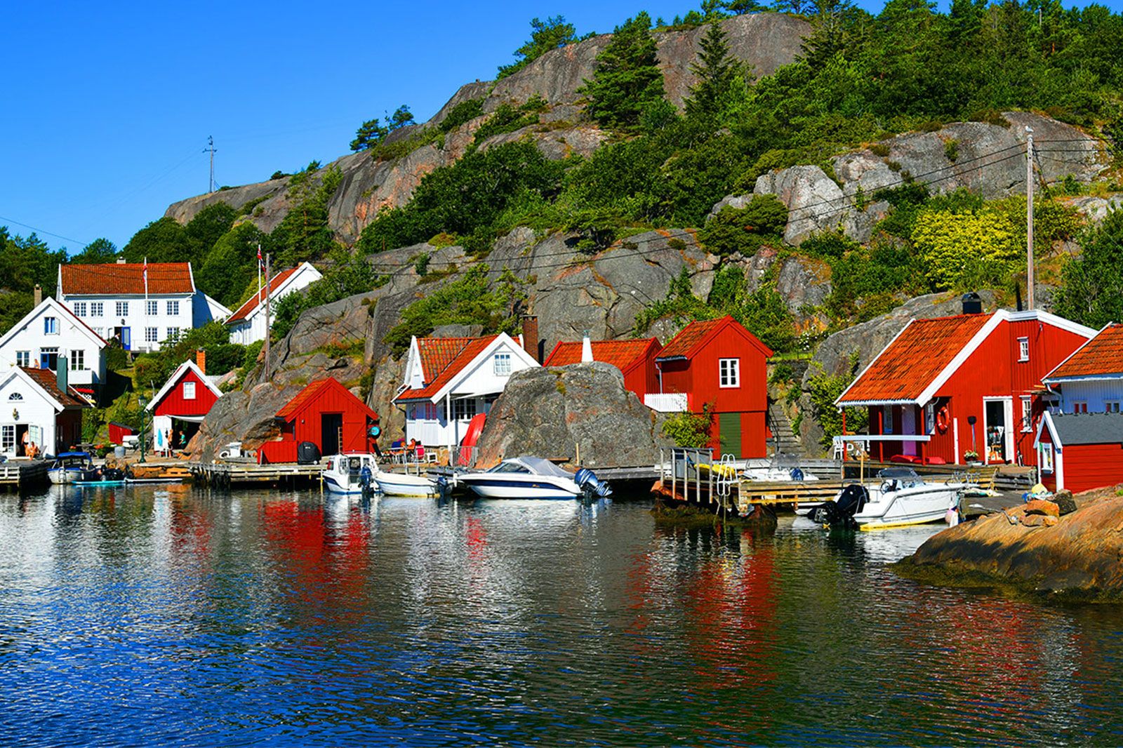 A town of red buildings along the water.